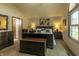 Bright main bedroom featuring a large bed, warm lighting, and classic wooden furniture at 421 Kingsway Ct, Mooresville, IN 46158