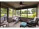 Inviting screened porch with brick accents and comfortable seating, perfect for relaxing and enjoying the outdoors at 421 Kingsway Ct, Mooresville, IN 46158