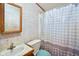 Bathroom featuring a single sink vanity and a shower-tub with a polka dot curtain at 4697 W Ridge Dr, Columbus, IN 47203