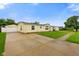 Charming single-story home with a well-maintained lawn and long concrete driveway at 4697 W Ridge Dr, Columbus, IN 47203