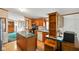 Functional kitchen with wooden cabinets, an island, and vintage-style wallpaper at 4697 W Ridge Dr, Columbus, IN 47203