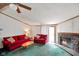 Comfortable living room featuring a fireplace, green carpet, and ample seating at 4697 W Ridge Dr, Columbus, IN 47203