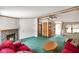 Spacious living room with a stone fireplace, plush red sofas, and green carpeting at 4697 W Ridge Dr, Columbus, IN 47203