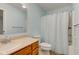 Bright bathroom featuring a vanity with ample storage, a large mirror, and a bathtub with shower at 524 S Meridian S St, Lebanon, IN 46052