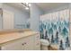 Bright bathroom featuring a vanity with ample storage, a large mirror, and a bathtub with shower at 524 S Meridian S St, Lebanon, IN 46052