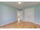 Bright bedroom featuring wood floors, light blue walls, and a double closet for storage at 524 S Meridian S St, Lebanon, IN 46052
