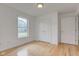 Bright bedroom featuring wood floors, white walls, a window, and a double closet for storage at 524 S Meridian S St, Lebanon, IN 46052