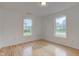 Bright bedroom featuring wood floors, white walls, and two windows for natural light at 524 S Meridian S St, Lebanon, IN 46052