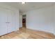 Bright bedroom featuring wood floors, white walls, and a double closet for storage at 524 S Meridian S St, Lebanon, IN 46052
