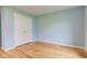 Bright bedroom featuring wood floors, light blue walls, and a double closet for storage at 524 S Meridian S St, Lebanon, IN 46052