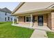 Inviting covered porch with brick accents, offering a welcoming entryway to the home at 524 S Meridian S St, Lebanon, IN 46052