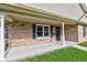 A close-up of a cozy front porch featuring brickwork and a screen door entrance at 524 S Meridian S St, Lebanon, IN 46052