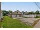 Two-car garage with a wide driveway, next to a white privacy fence and grassy areas at 524 S Meridian S St, Lebanon, IN 46052