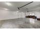 Large garage with workbench, lawnmower, and bright overhead lighting at 524 S Meridian S St, Lebanon, IN 46052