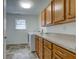 Laundry room featuring wooden cabinets, washer and dryer, and a window at 524 S Meridian S St, Lebanon, IN 46052