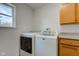 Close up of washing machine and dryer in laundry room with small window at 524 S Meridian S St, Lebanon, IN 46052