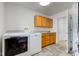 Laundry room with washer/dryer, cabinets and door leading to another area at 524 S Meridian S St, Lebanon, IN 46052