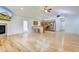 Spacious living room with hardwood floors, an open kitchen, and a cozy fireplace at 524 S Meridian S St, Lebanon, IN 46052