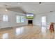 Open-concept living space featuring hardwood floors and a fireplace with mounted television at 524 S Meridian S St, Lebanon, IN 46052