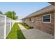 Brick home exterior featuring a well-maintained yard and a white privacy fence at 524 S Meridian S St, Lebanon, IN 46052