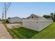 Side yard with a white privacy fence and partial views of other homes and a paved walkway at 524 S Meridian S St, Lebanon, IN 46052