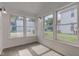 Bright sunroom filled with natural light from numerous windows, offering serene neighborhood views at 524 S Meridian S St, Lebanon, IN 46052