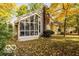 View of the backyard with a screened-in porch, lush greenery, and a peaceful setting at 5303 Windridge Dr # 172, Indianapolis, IN 46226