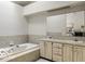 Well-maintained bathroom with double vanity, ample storage, and tub perfect for relaxation at 5303 Windridge Dr # 172, Indianapolis, IN 46226