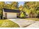 Charming single-story home featuring a brick facade, an attached two-car garage, and a concrete driveway at 5303 Windridge Dr # 172, Indianapolis, IN 46226