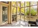 Enclosed sunroom with lots of windows and wood flooring, perfect for enjoying outdoor views at 5303 Windridge Dr # 172, Indianapolis, IN 46226