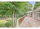 Scenic backyard view from a spacious wooden deck surrounded by lush greenery and mature trees at 545 Pitney Dr, Noblesville, IN 46062