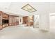 Expansive basement boasts a wet bar and built-in display cabinet alongside carpet floors and painted walls at 545 Pitney Dr, Noblesville, IN 46062
