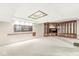 Spacious finished basement with built-in wooden cabinets and display cases, plus an ornate stained glass ceiling accent at 545 Pitney Dr, Noblesville, IN 46062