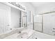 Well-lit bathroom features a combined tub and shower, a marble countertop vanity, and tiled floors at 545 Pitney Dr, Noblesville, IN 46062