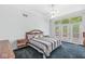 Bright bedroom with a vaulted ceiling, fan and an abundance of natural light and doors to the outside at 545 Pitney Dr, Noblesville, IN 46062