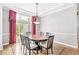 Cozy dining room with a round table, six chairs, and large window with red curtains at 545 Pitney Dr, Noblesville, IN 46062