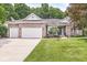 Inviting single-story brick home featuring a three-car garage and manicured lawn at 545 Pitney Dr, Noblesville, IN 46062