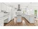 Modern kitchen with stainless steel appliances, an island, and white cabinetry offering ample storage space at 545 Pitney Dr, Noblesville, IN 46062