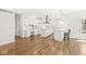 Spacious kitchen with white cabinetry, an island, stainless steel appliances, and hardwood flooring at 545 Pitney Dr, Noblesville, IN 46062