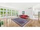 Bright and airy living room with hardwood floors, large windows, and a cozy seating area at 545 Pitney Dr, Noblesville, IN 46062