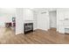 Open living room with a fireplace, built-in shelving, and seamless flow to other living spaces at 545 Pitney Dr, Noblesville, IN 46062