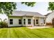 Back exterior of home with a patio, well-manicured lawn, large windows, and light vinyl siding at 5883 Hollow Oak, Carmel, IN 46033