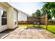 Private backyard with a stone patio, manicured lawn, privacy fence and mature trees at 5883 Hollow Oak, Carmel, IN 46033