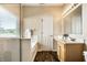 Bathroom features a glass shower, soaking tub, vanity, and warm lighting at 5883 Hollow Oak, Carmel, IN 46033