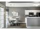 Bright dining area with a table and chairs, adjacent to the kitchen with modern appliances at 5883 Hollow Oak, Carmel, IN 46033