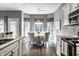 Bright dining area boasts a large bay window, chandelier, and seating for four at 5883 Hollow Oak, Carmel, IN 46033