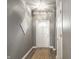 Clean entryway featuring a white front door, stylish wall decor, and modern flooring at 5883 Hollow Oak, Carmel, IN 46033