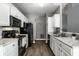 Modern kitchen with stainless steel appliances, sleek countertops, and ample cabinet space at 5883 Hollow Oak, Carmel, IN 46033