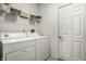 Functional laundry room with storage shelves and washer and dryer hookups at 5883 Hollow Oak, Carmel, IN 46033