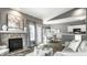 Open-concept living space with fireplace, dining area, and view of the kitchen at 5883 Hollow Oak, Carmel, IN 46033